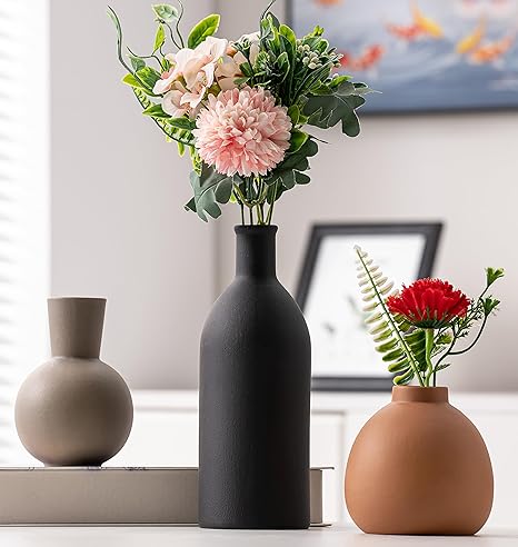 Beige ceramic vase set on wooden table